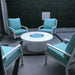 White round outdoor metal powdered coated fire pit set on a patio surrounded by four light blue cushioned chairs