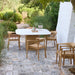 Outdoor patio with a square outdoor dining table and wooden stackable outdoor armchairs