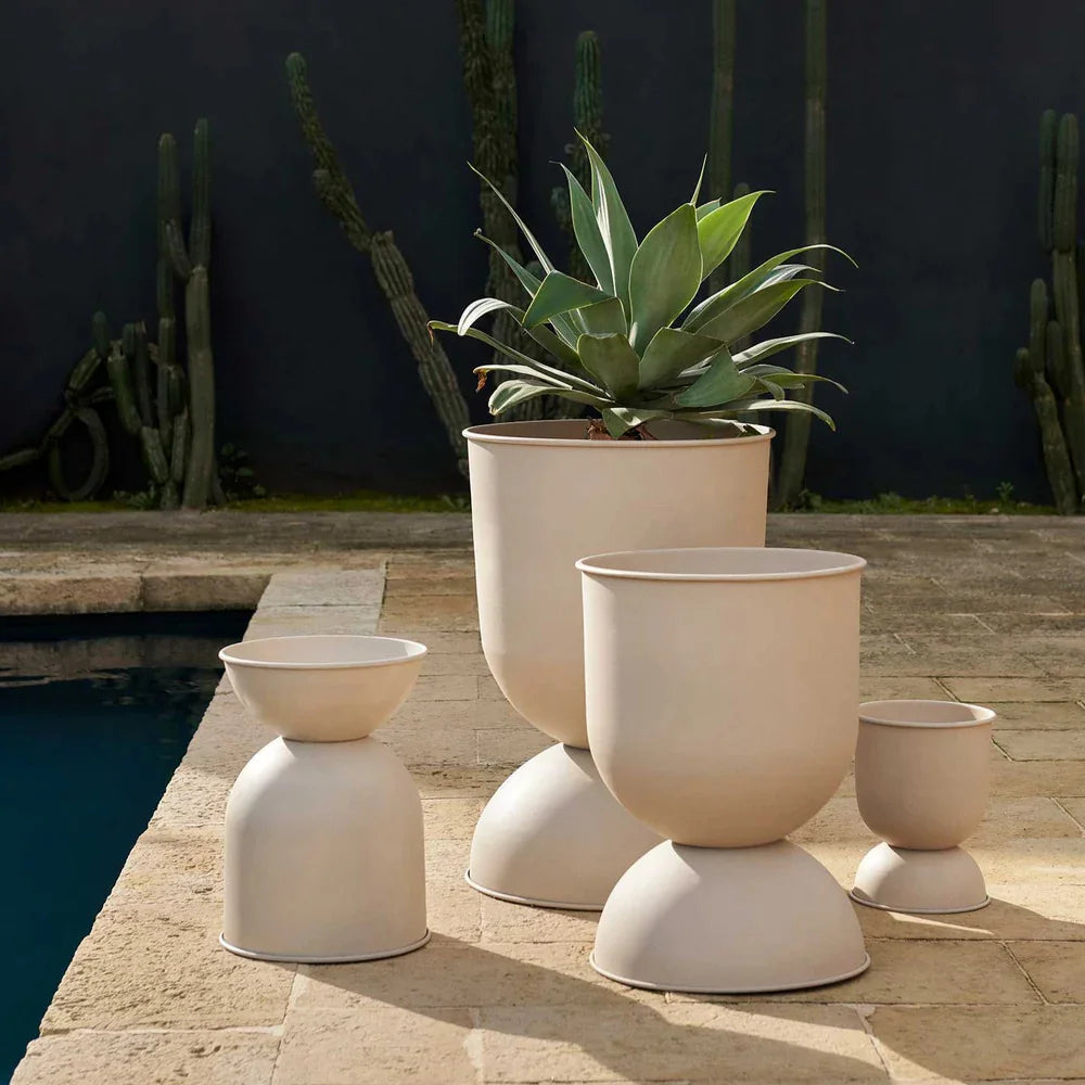 Set of beige outdoor planters with a cactus in the background