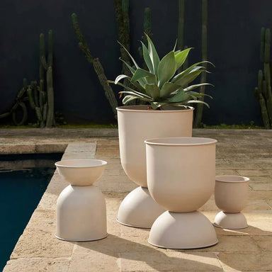 Set of beige outdoor planters with a cactus in the background