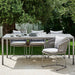 Boxhill's Moments Outdoor Dining Armchair lifestyle image with dining table with random things on top at patio