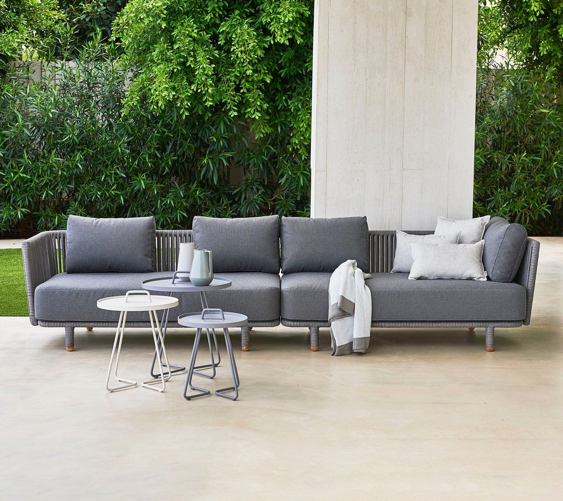 Boxhill's Moments 2-Seater Left Module Sofa lifestyle image with Moments 2-Seater Right Module Sofa and 3 round table at patio