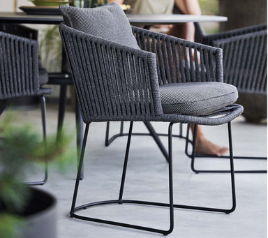 Boxhill's Moments Outdoor Dining Armchair lifestyle image at patio