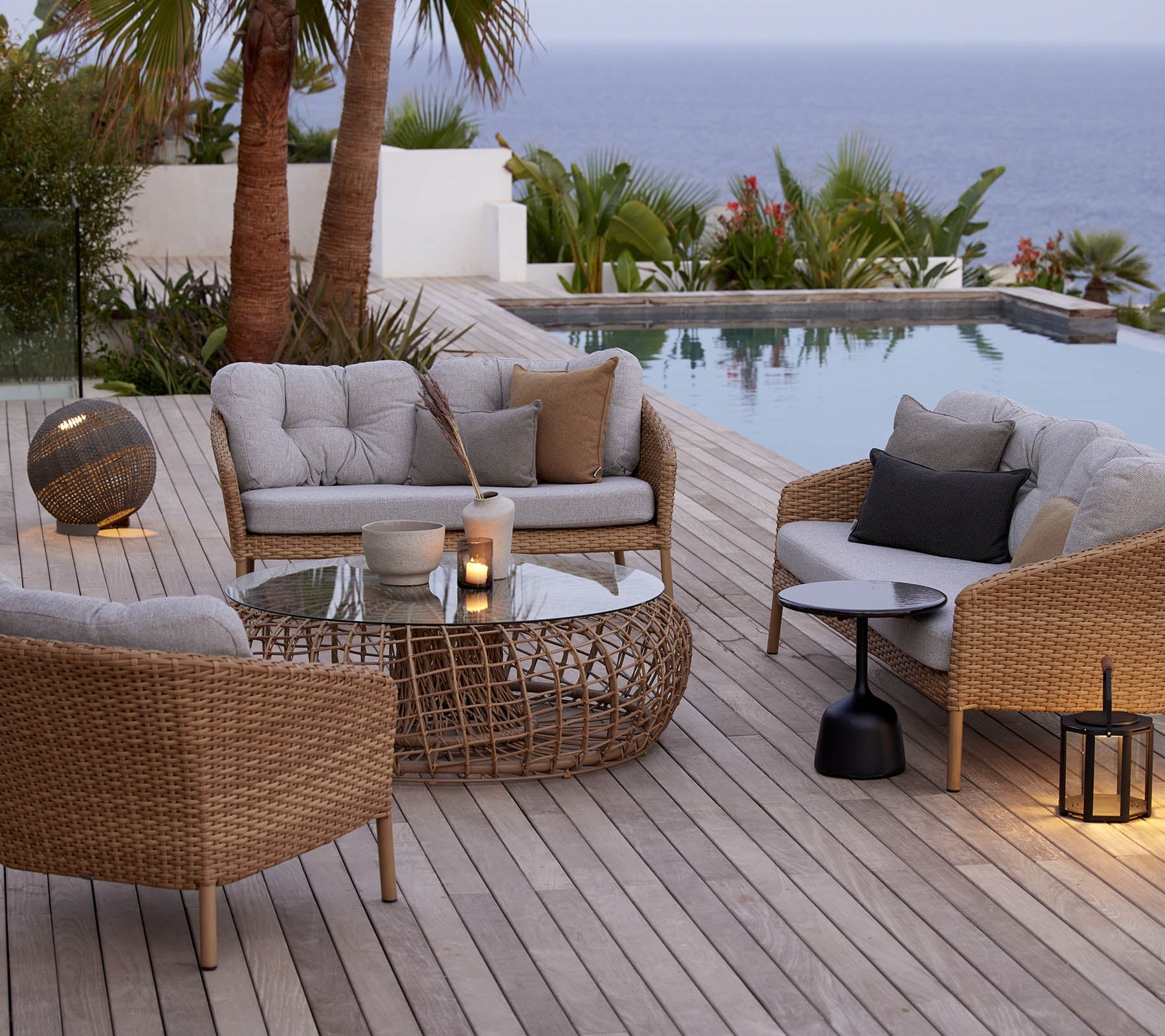 Boxhill's Ocean Large Outdoor Lounge Chair lifestyle image with other Ocean Sofa Collection and  Nest Footstool/Coffee Table Outdoor Large beside the pool