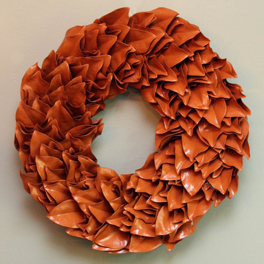 Orange ruffled wreath on a light background