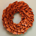 Orange ruffled wreath on a light background