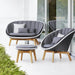   Boxhill's Peacock grey outdoor 2-seater sofa with teak base and grey outdoor lounge chair with teak base placed in patio