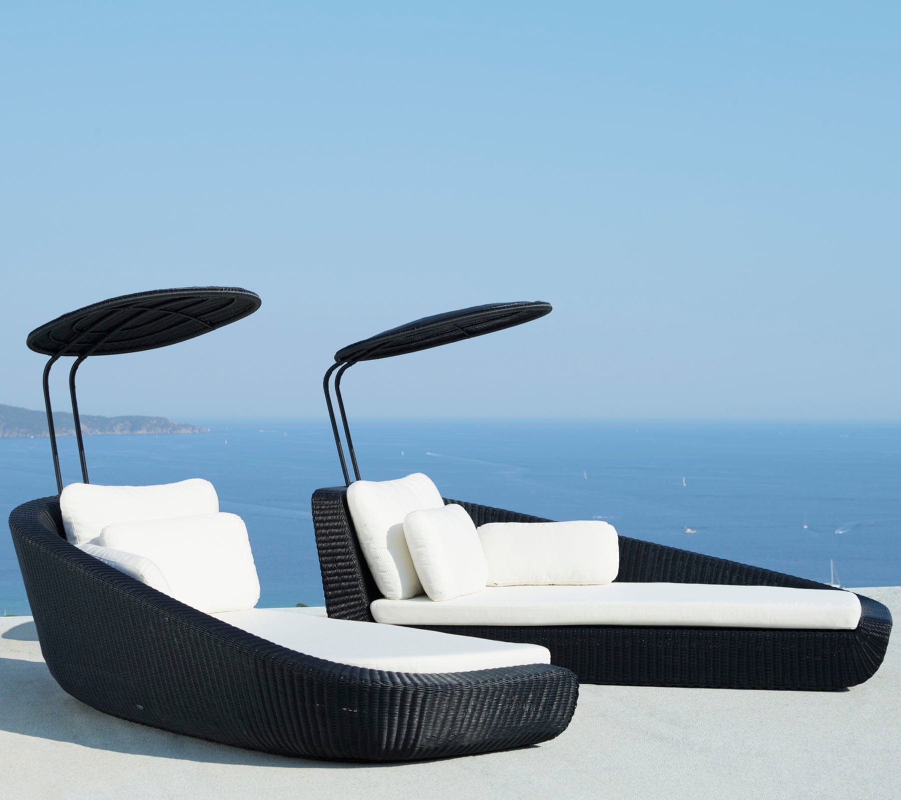 Boxhill's Savannah black outdoor  sectional chaise lounge with shade with white cushion and a sea view background