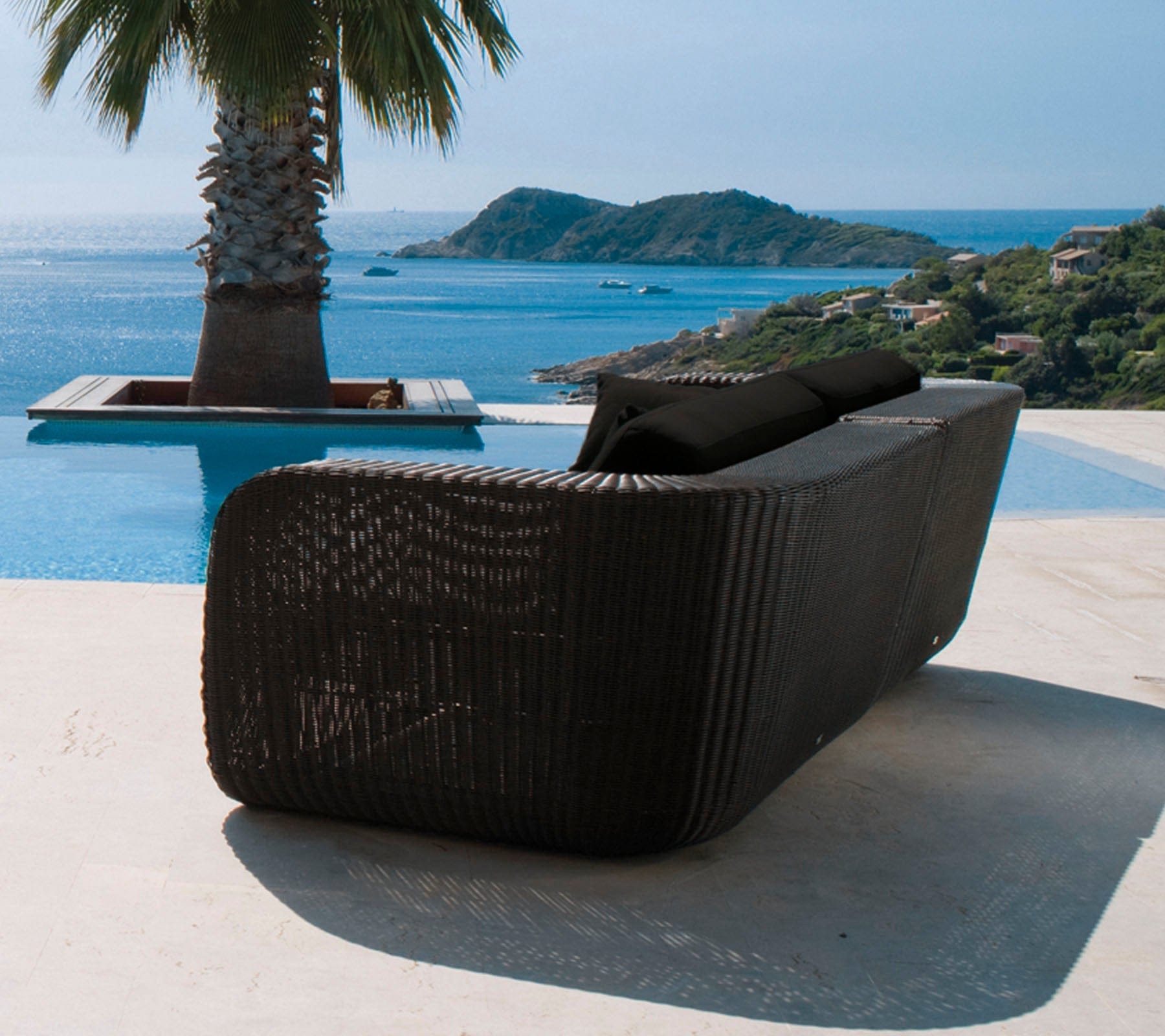 Boxhill's Savannah black outdoor sectional sofa with black cushion placed beside the pool