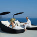 Boxhill's Savannah black outdoor  sectional chaise lounge with shade with white cushion, with man and woman sitting on it