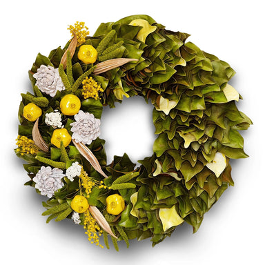 Festive wreath with natural and magnolia leaf accents in yellow green hues.