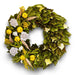Decorative wreath with natural and magnolia leaf accents in yellow green hues