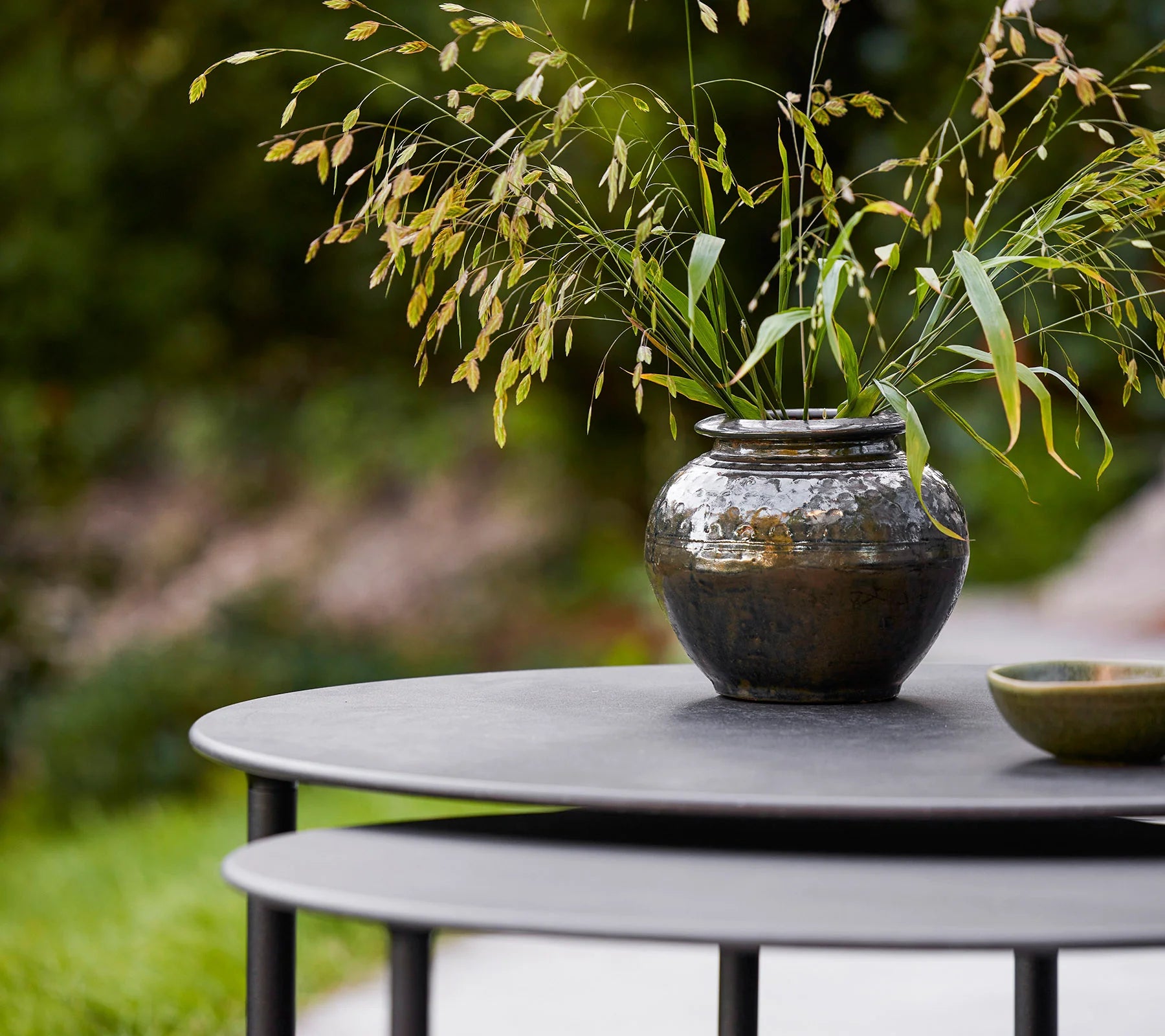  Boxhill's Twist grey outdoor round coffee table with plants in a pot on it 