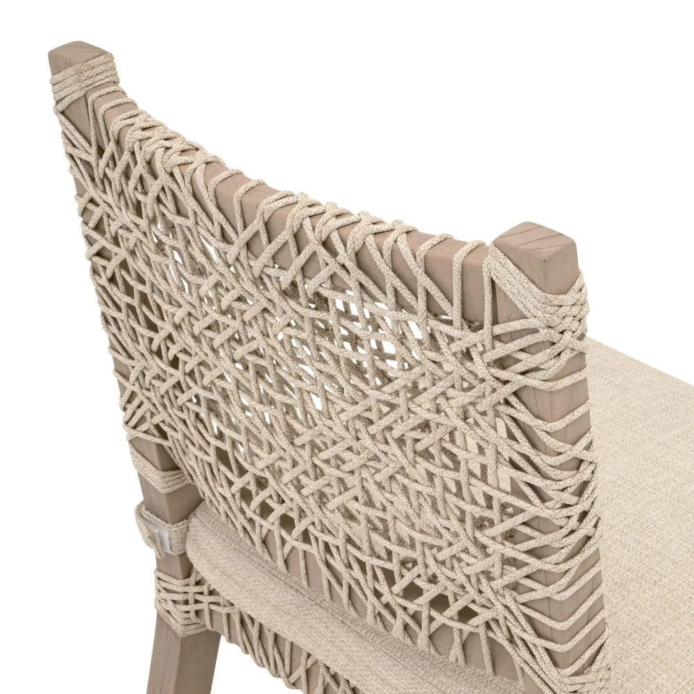 Close-up of a chair with woven backrest and beige cushion on a white background