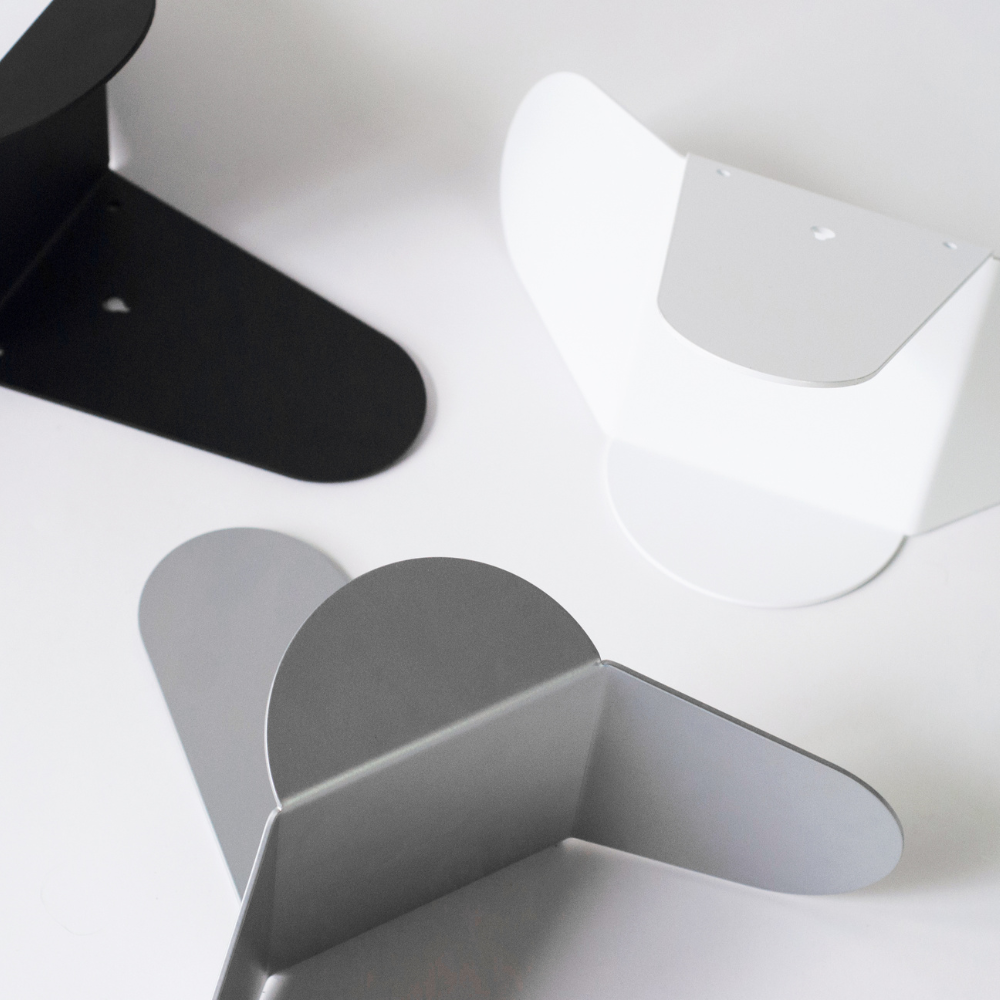 Close-up of geometric metal hose holder reel pieces on a white background