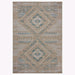 A rectangular area outdoor rug with a woven geometric pattern featuring two large diamond motifs and horizontal striped bands. The color palette consists of a natural tan/beige base with accents of muted blue, gray, and off-white.