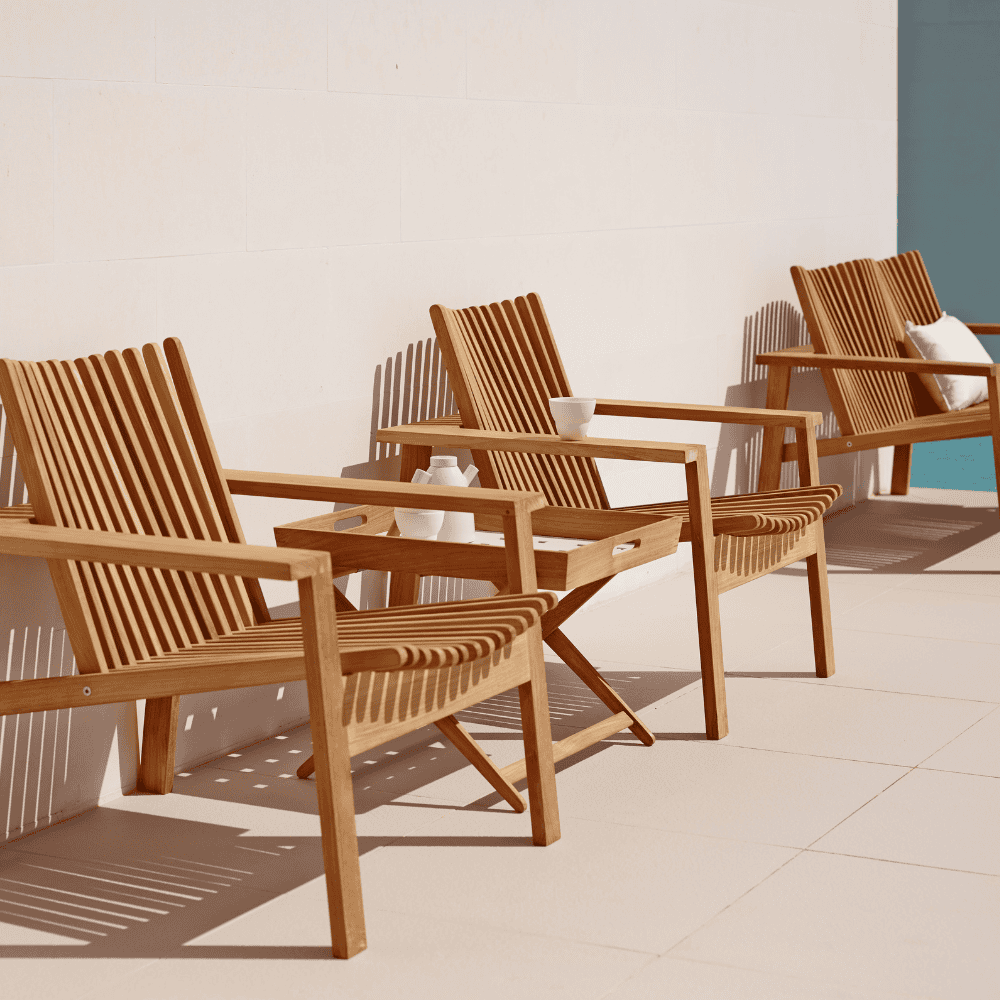 Boxhill's Amaze Stackable Lounge Teak Chair lifestyle image without cushion
