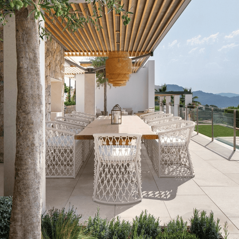 Boxhill's Amelia Outdoor Dining Chair Sand lifestyle with long dining table