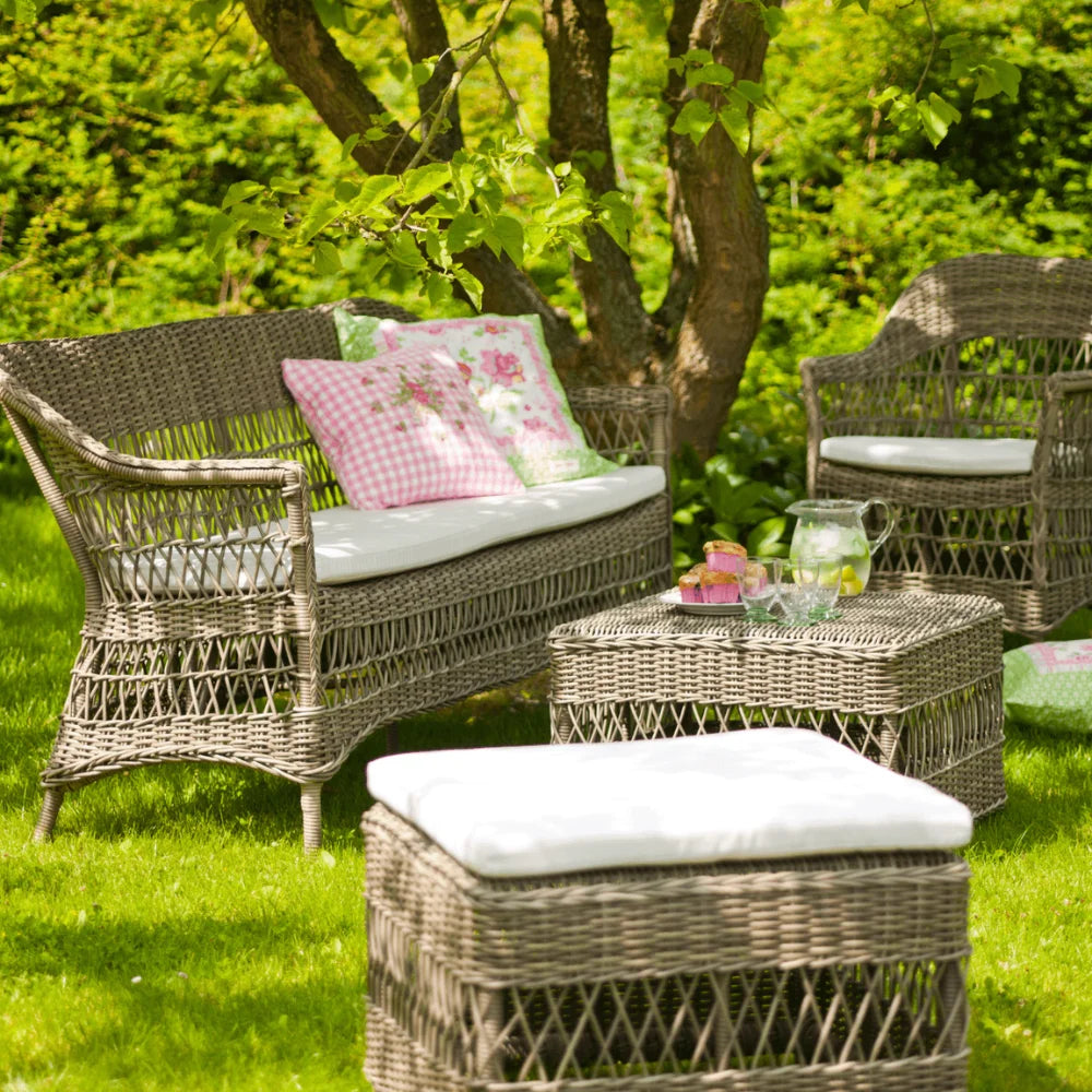 A complete wicker garden set with two side table and chairs, perfect for enjoying meals in an outdoor setting.