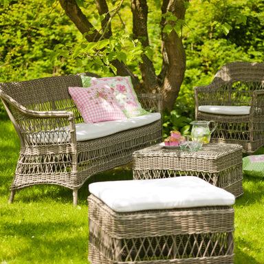 A complete wicker garden set with two side table and chairs, perfect for enjoying meals in an outdoor setting.