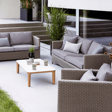 Boxhill's Aspect Rectangle Coffee Table Travertine Look lifestlye image at the center of outdoor sofa 