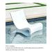 A white curved in-pool lounge chair placed in a swimming pool, with a beige deck and green grass border visible behind it. Text below reads 'Drier Lounging' and describes the raised seat profile keeping the user above the waterline.