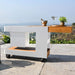 Outdoor cart with white base and wooden top on a patio with scenic background