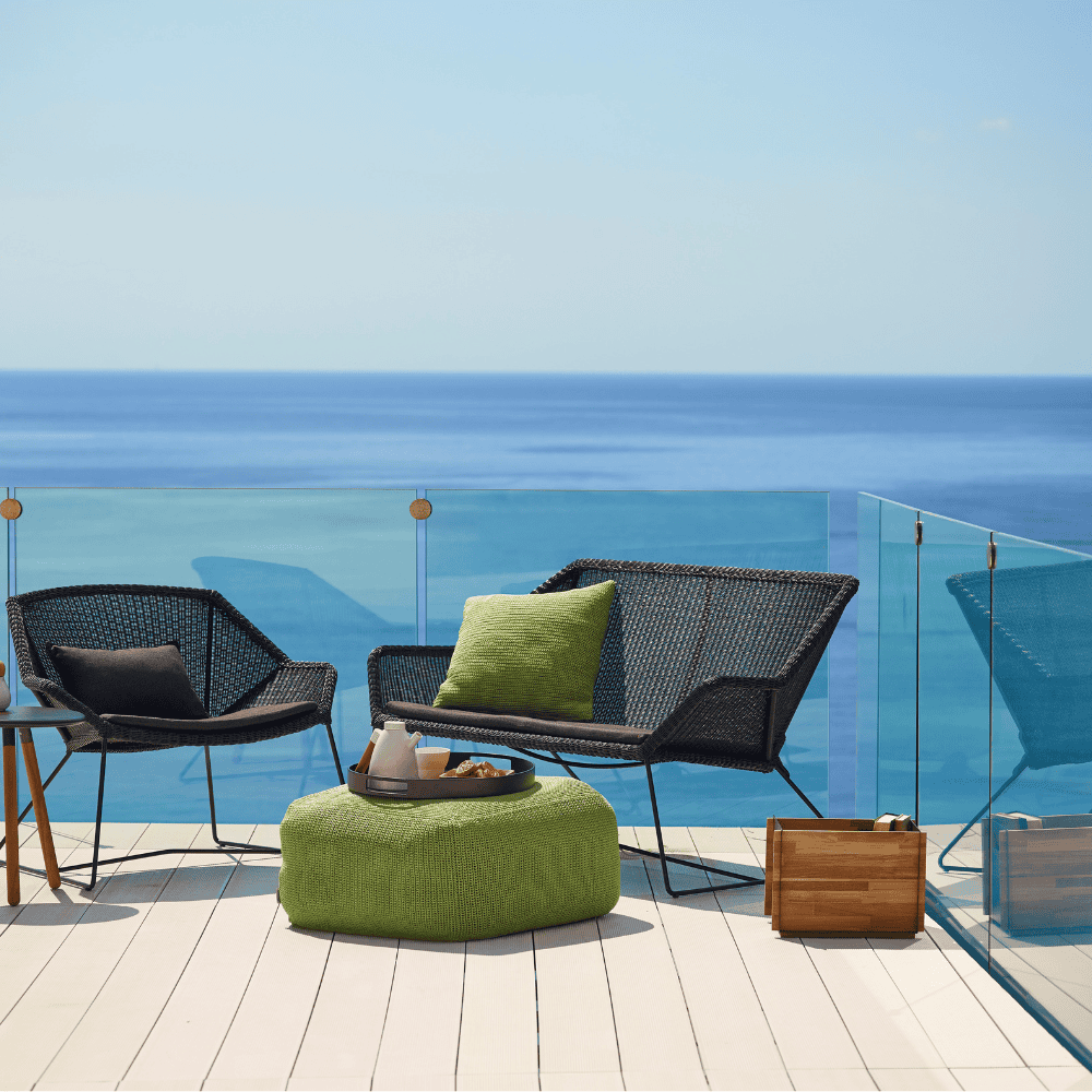 Boxhill's Breeze 2-Seater Outdoor Garden Sofa Black lifestyle image on the roof top at seafront