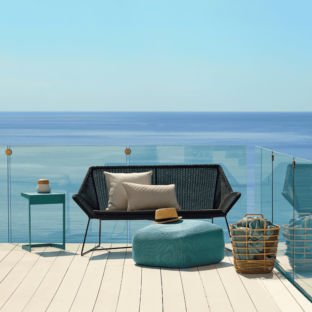 Boxhill's Breeze 2-Seater Outdoor Garden Sofa Black lifestyle image on the roof top at seafront