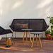 Boxhills' Breeze 2-Seater Outdoor Garden Sofa Black lifestyle image with 2 Area Coffee Table Chair on wooden platform