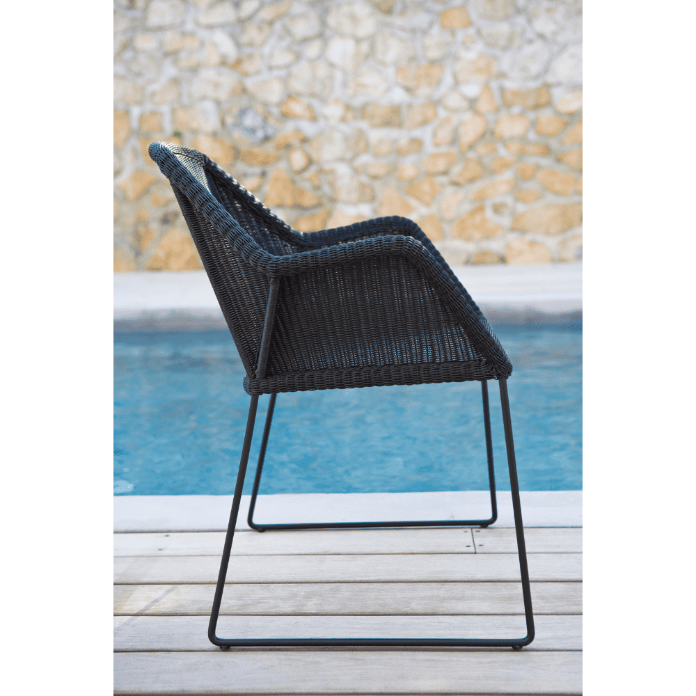 Boxhill's Breeze Dining Weave Chair Black lifestyle image side view beside the pool