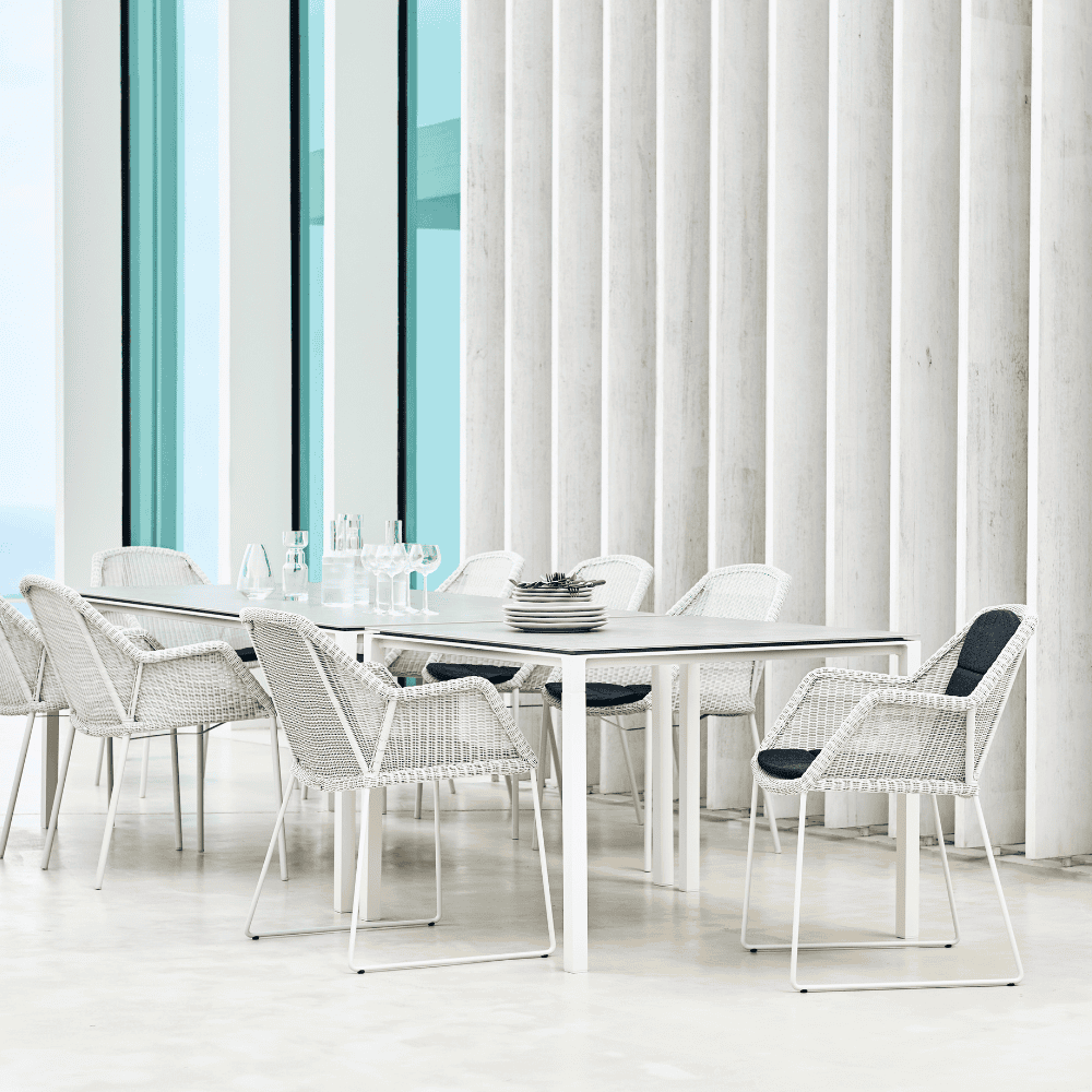 Boxhill's Breeze Dining Weave Chair White Grey lifestyle image around tables with plates and glass of water on top