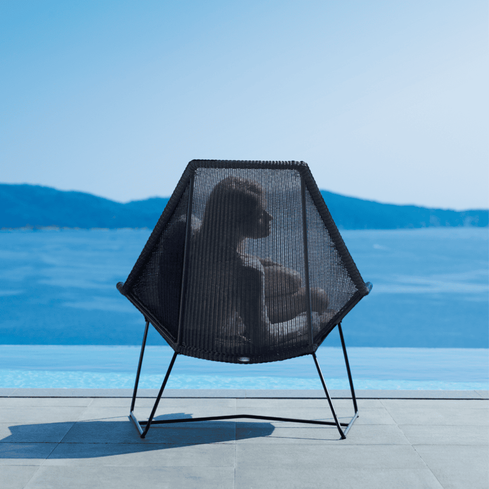 Boxhill's Breeze Highback Outdoor Chair Black lifestyle image back view with woman sitting down