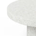 Close-up of white textured round concrete patio dining table in a white background