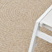 Round outdoor rug in brown woven material with textured pattern