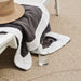 Outdoor rug in brown woven material with textured pattern, close-up view