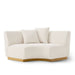 White outdoor sofa with wooden legs.