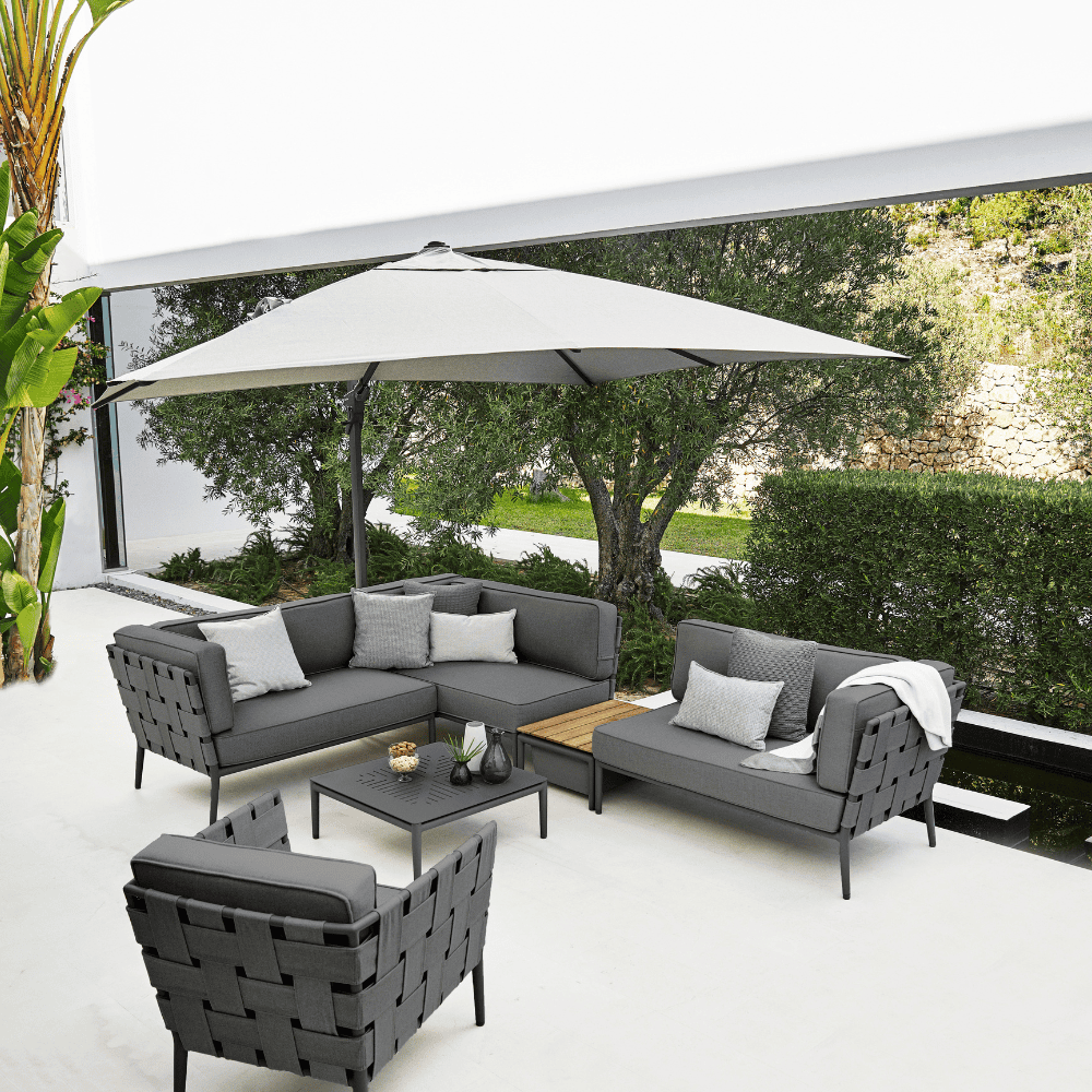 Boxhill's Conic 2-Seater Left Module Sofa Grey lifestyle image with big umbrella sunshade at patio