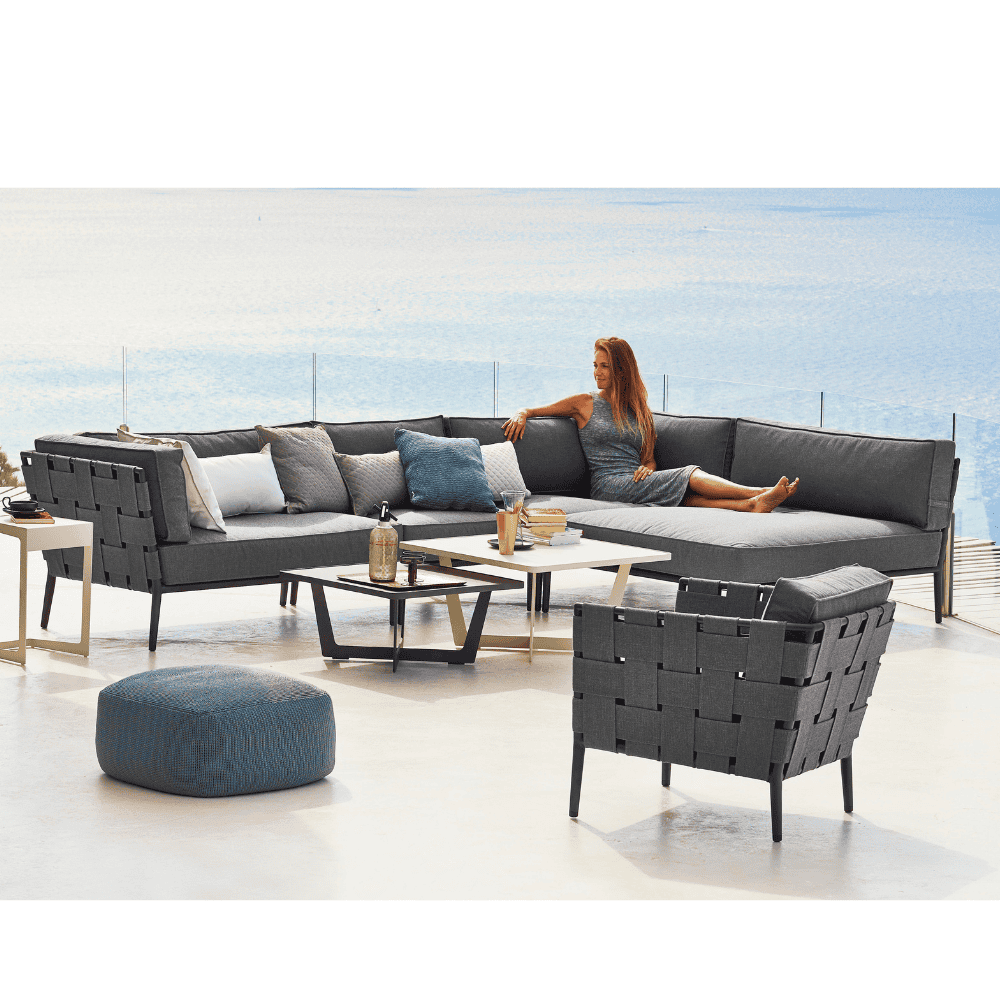 Boxhill's Conic Single Seater Sofa Module Grey lifestyle image with Conic Module Sofa and Conic Loung Chair with woman sitting down