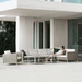 Boxhill's Connect 2-Seater Left Module Sofa lifestyle image with other Connect Module Sofa and Connect Lounge Chair with a woman sitting down at patio