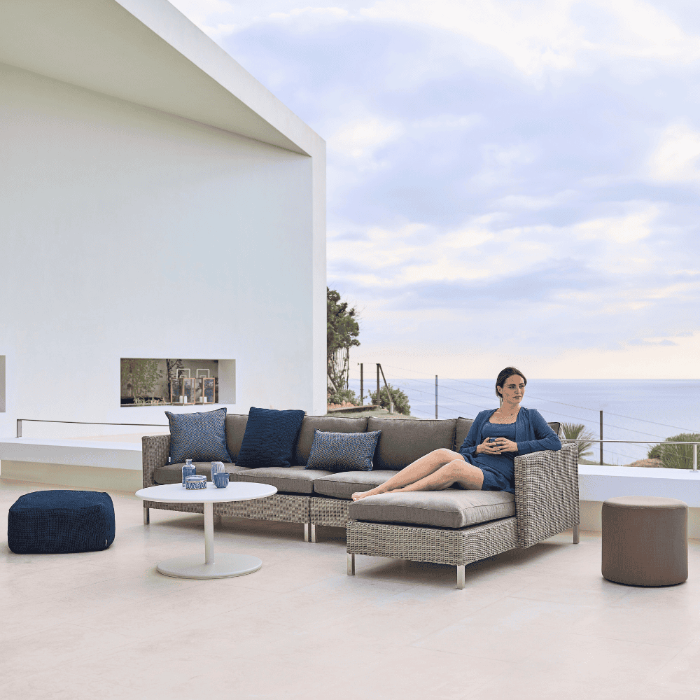 Boxhill's Connect Module Sofa lifestyle image with other module sofa and a woman sitting down at patio
