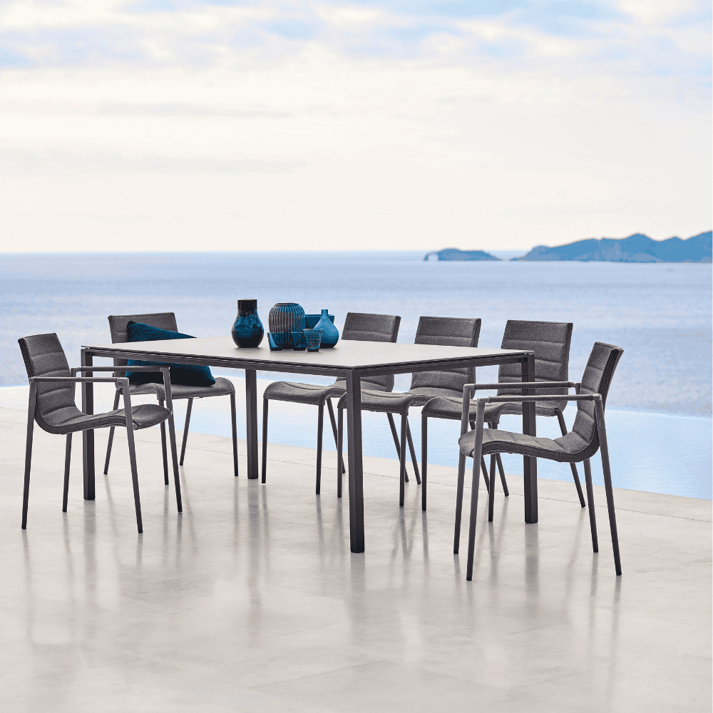 Boxhill's Core Patio Dining Armchair (Set of 2) Grey lifestyle image with dining table beside the pool