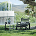Boxhill's Curve Lounge Weave Outdoor Chair Graphite lifestyle image with 2 round table at the garden