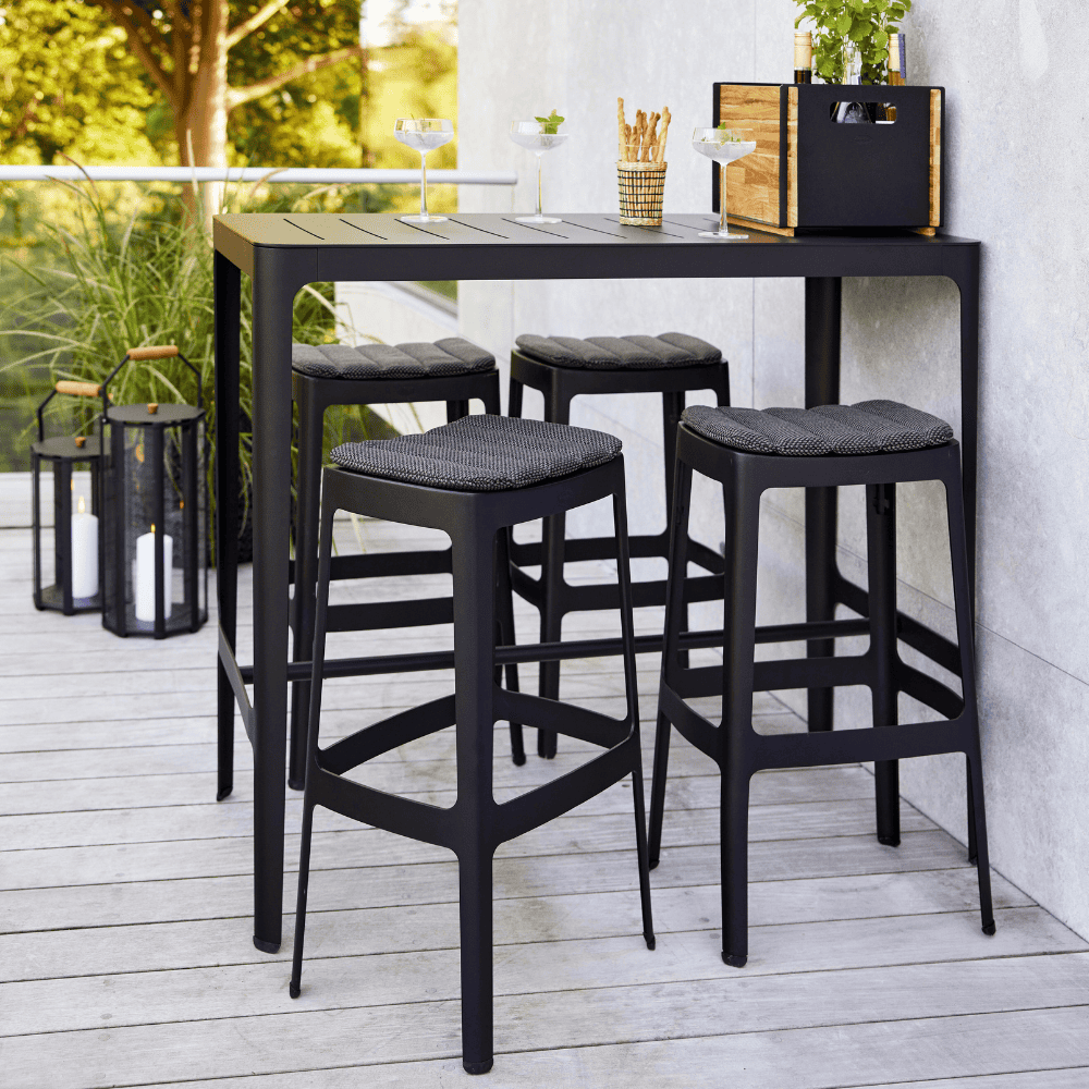Boxhill's Cut High Outdoor Bar Chair Black with Dark Grey Cushion lifestyle image with Cut High Outdoor Bar Table on balcony