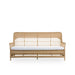 Natural wicker outdoor 3-seater sofa in a light tan finish with a white seat cushion and open woven back.