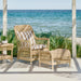 Natural wicker outdoor woven stool with matching armchair and side table featuring striped beige and white cushions.