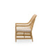 Natural wicker outdoor armchair in a light tan finish with a white seat cushion viewed from the side.