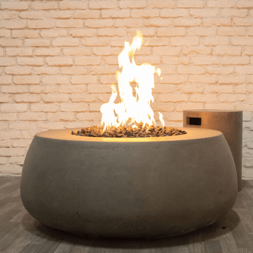 Dune Fire Bowl is a handcrafted outdoor concrete round fire bowl in grey with pebble stones by Boxhill
