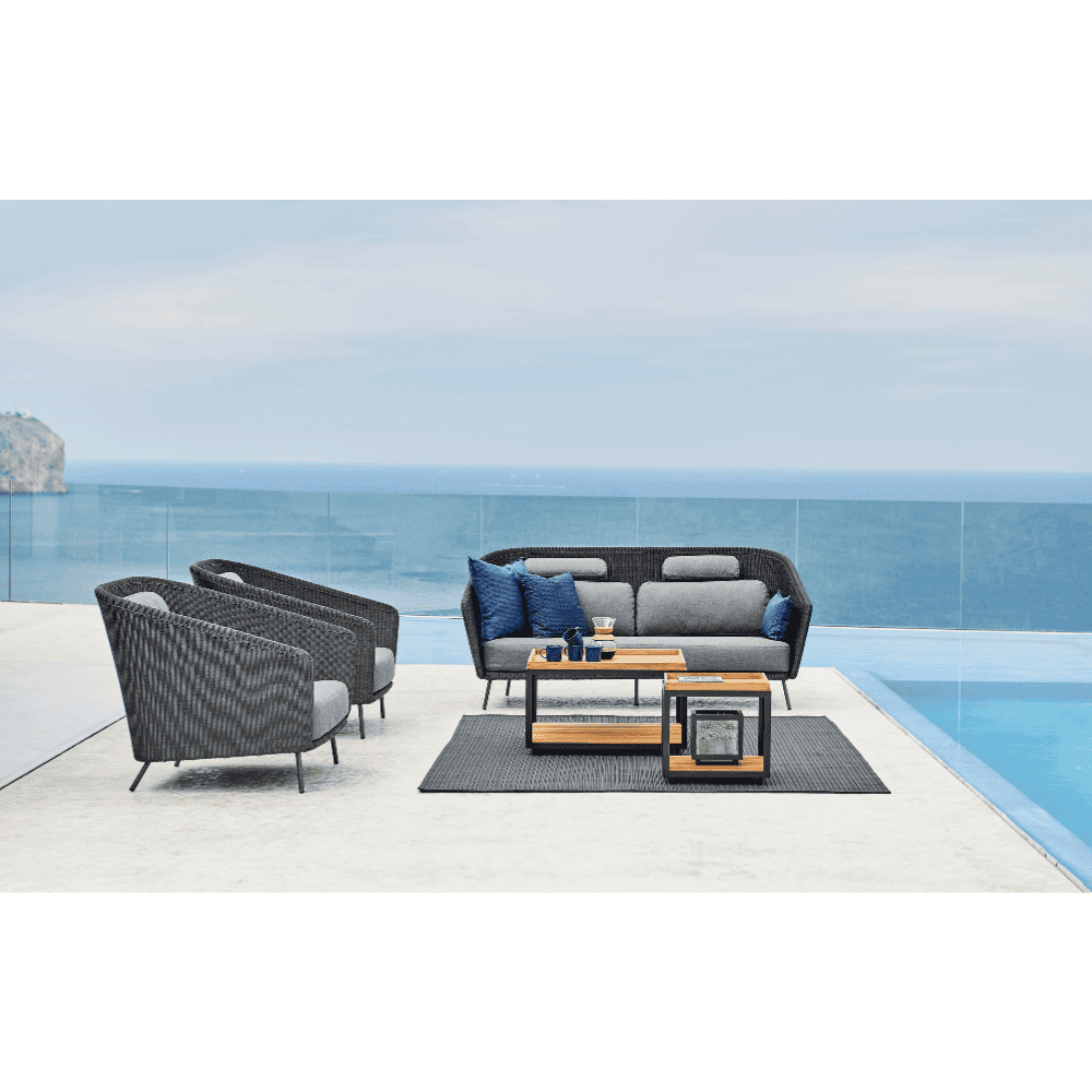 Boxhill's Mega Modern Outdoor Lounge Chair lifestyle image beside the pool with Mega Modern Outdoor 2-Seater Sofa and 2 Level Coffee Table with Teak Top beside the pool