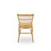 Natural rattan outdoor dining side chair in a light tan finish featuring an open slatted back viewed from the rear.